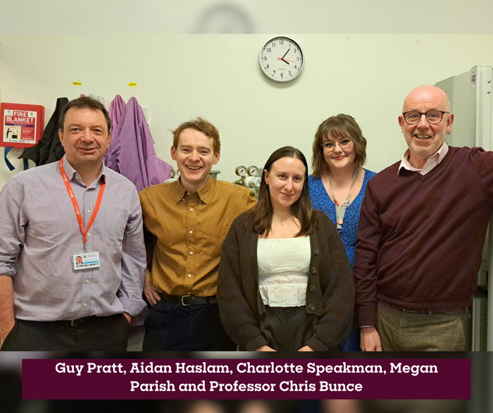 Professor Chris Bunce and his team smiling in the lab.
