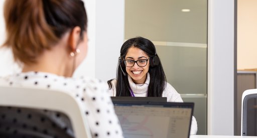 A staff member at Blood Cancer UK smiling at their computer