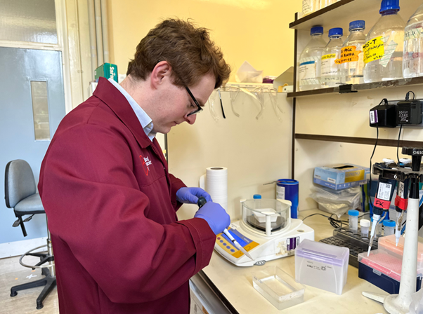 Man looking at equipment in a lab side on