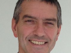A headshot of Professor Pettitt smiling.