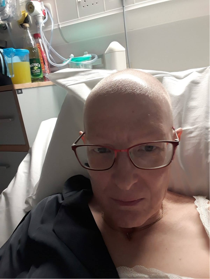 Becky, lying in a hospital bed