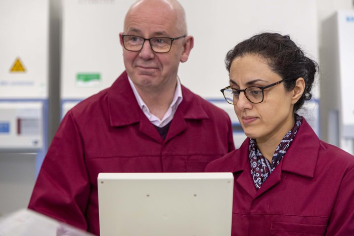 Professor Chris Bunce and Dr Farhat Latif Khanim look at a screen together in a research lab.