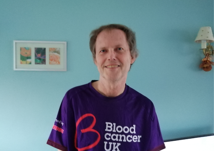 David Lauder wearing a purple branded Blood Cancer UK t-shirt.