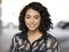 Fatima Sulaiman, former Head of Research at Blood Cancer UK looking at camera.