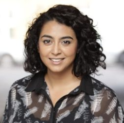 Fatima Sulaiman, former Head of Research at Blood Cancer UK looking at camera.