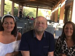 A daughter, father and mother sit together in an empty cafe.