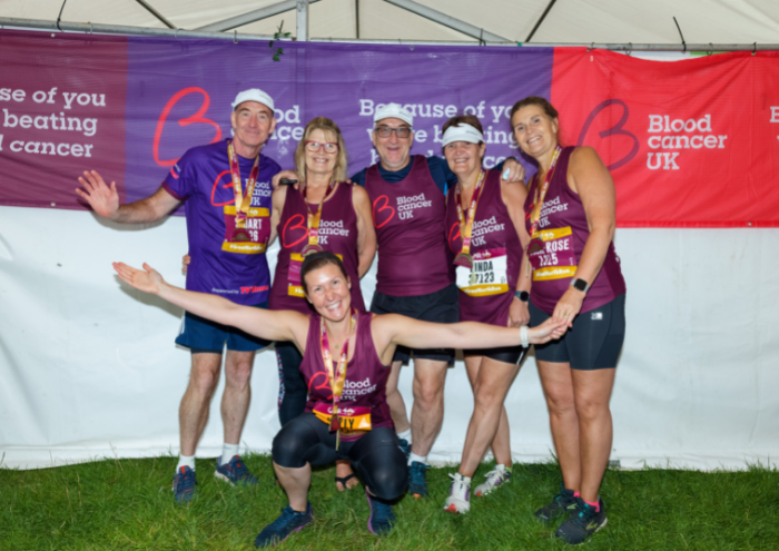Group of Great North Run supporters posing by Blood Cancer UK banners