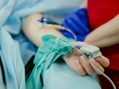 Close up of someone having blood pressure taken via pulse oximeter blood pressure reader.