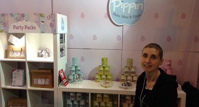 Louise MacLeod working in her family shop, with products behind her in the background.