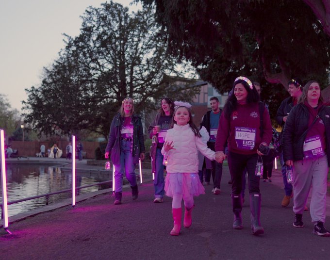 Daughter and Mother holding hands through the light tunnel at Walk of Light Birmingham