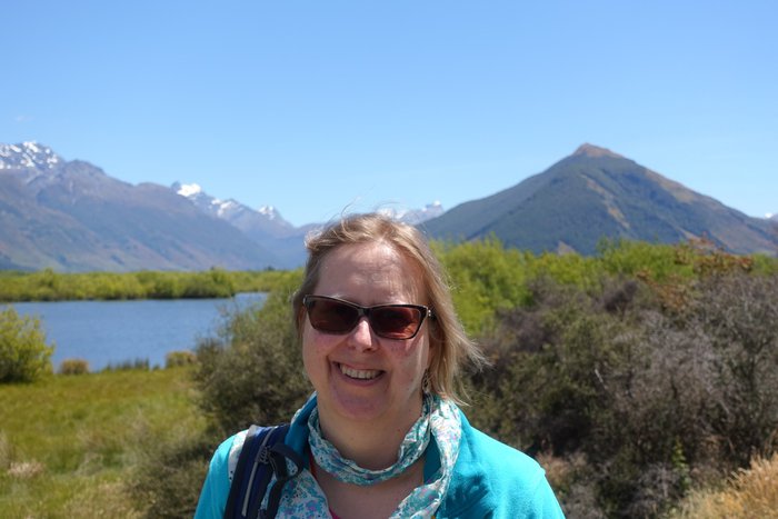 Photo of Carole outside on a hike smiling