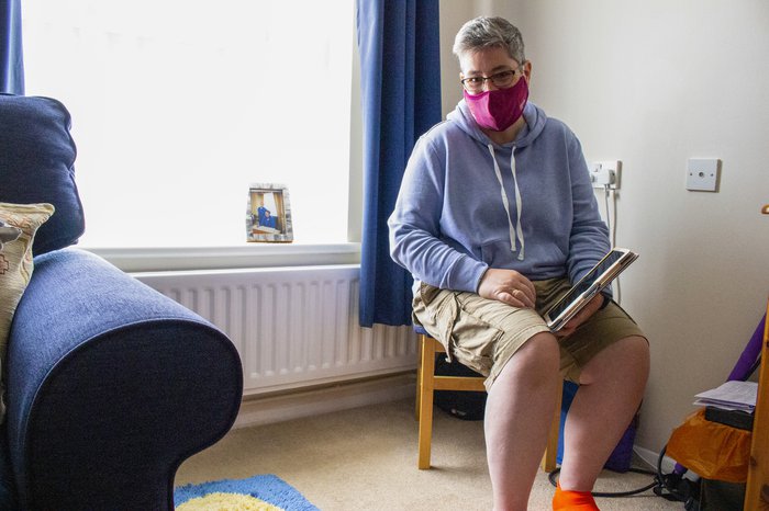 Angie wearing a facemask indoors