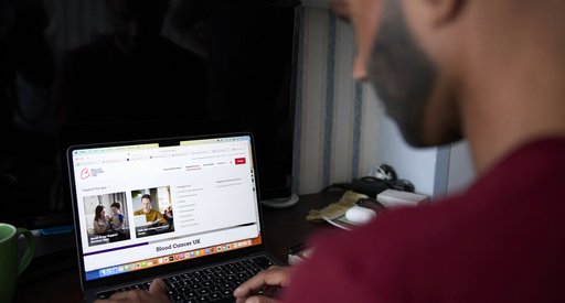 An Asian man looking at blood cancer information on the Blood Cancer UK website.
