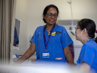 Nurses in blue tunics working in a hospital