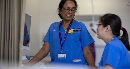 Nurses in blue tunics working in a hospital