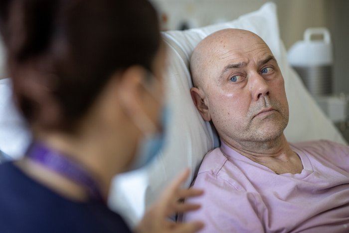 An image of a man in a hospital bed.