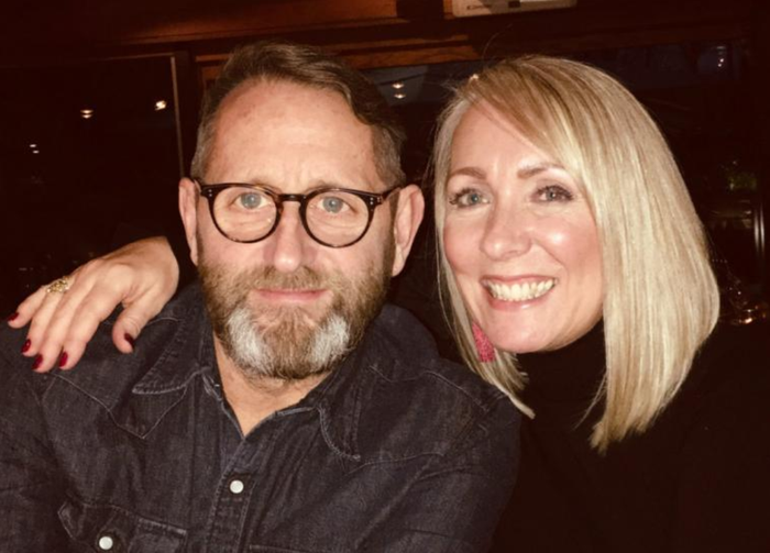 Sara, who was diagnosed with Waldenström macroglobulinaemia (WM), with her arm round her husband and smiling.