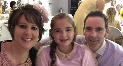 Anna, who was diagnosed with acute myeloid leukaemia (AML), with family at a formal function smiling at the camera.