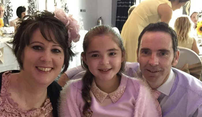 Anna, who was diagnosed with acute myeloid leukaemia (AML), with family at a formal function smiling at the camera.