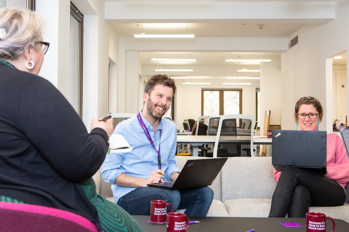 Blood Cancer UK staff looking happy in an informal meeting.