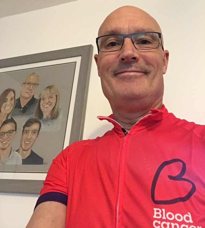 Steven, who was diagnosed with myeloma, smiling at the camera wearing his Blood Cancer UK cycling jersey.