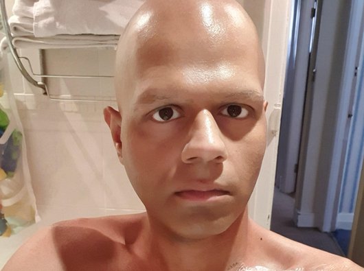 A man named Sunny takes a selfie as he received treatment via a drip in hospital.