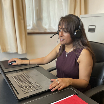 A woman is talking using a headset