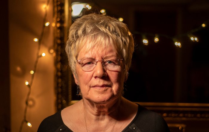 Sylvia Gaunt, daughter of Blood Cancer UK's founders David and Hilda Eastwood, looking into the camera with fairy lights on in the background.