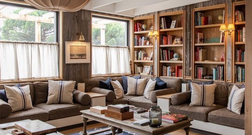 Large, bright, sitting room in the Gallivant with a book wall and comfortable sofas.