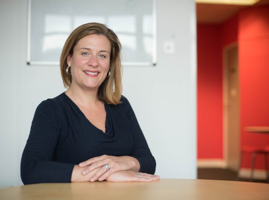 Former Blood Cancer UK Chief Executive Gemma Peters sitting with her arms crossed at a table.