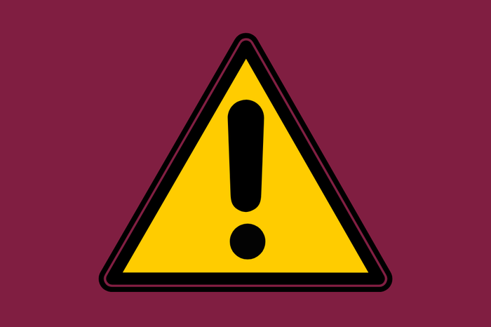 A warning icon of a yellow triangle with a black exclamation mark, on a maroon background.