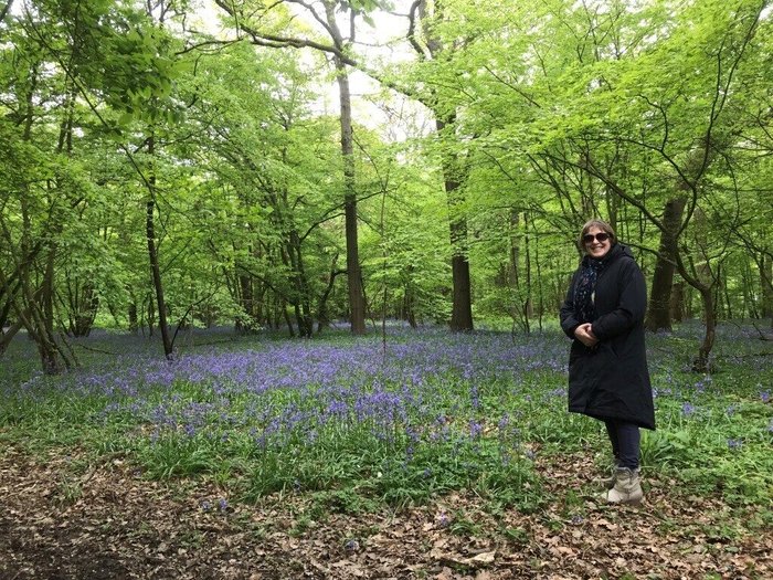 Rachel stands in a forest