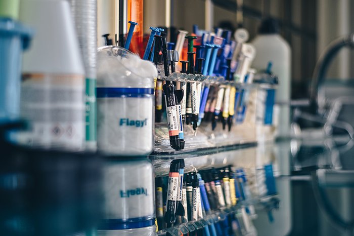 A rack of syringes on a table in a laboratory.