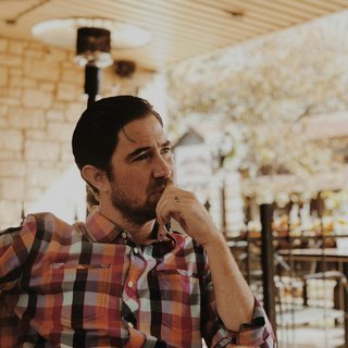 A man looking away from the camera, deep in thought
