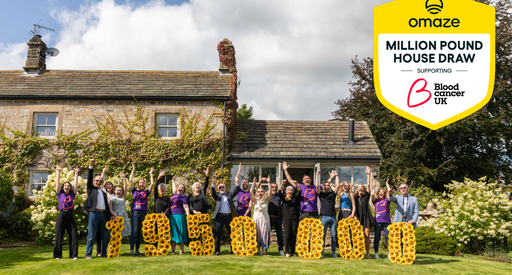 A group of people happy holding up the amount of money raised.