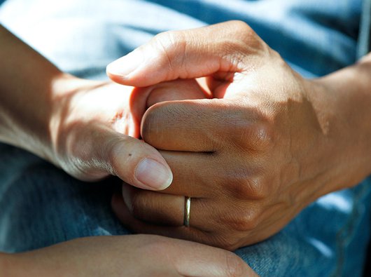 A close up of two people holding hands