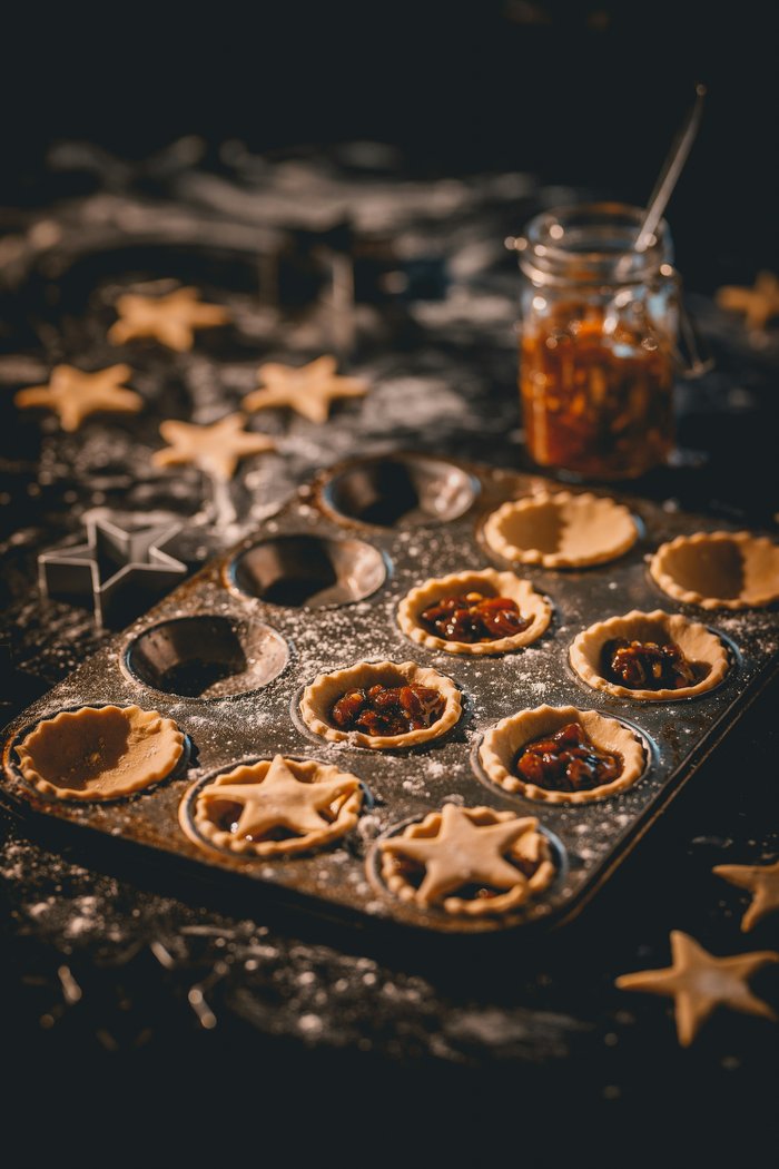 A tray of mince pies being prepared for baking.